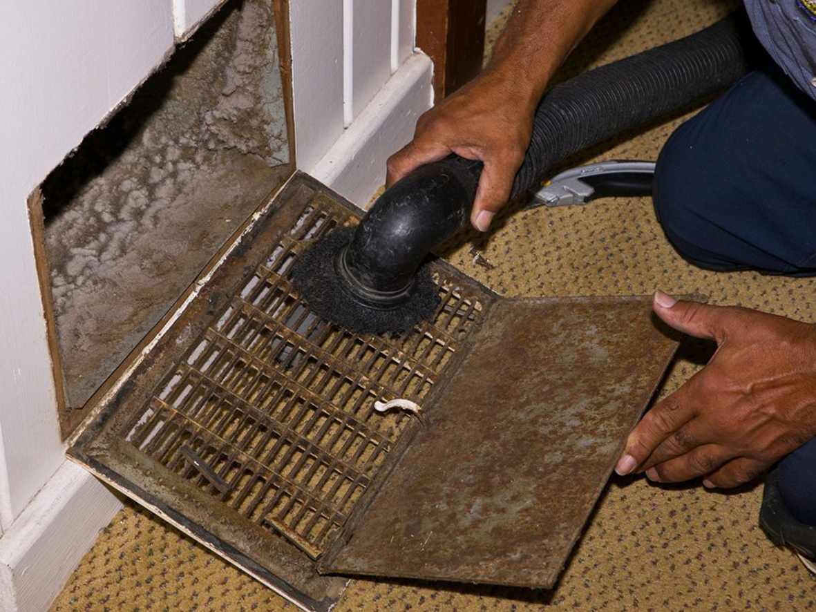 a man doing ac duct cleaning