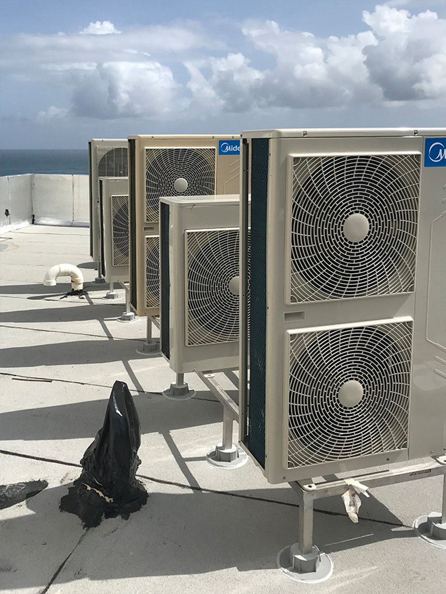 industrial ac units installed on the roof of a building